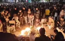 A group of citizens putting on candles at the Vladislav Ribnikar Elementary School, following the school shooting